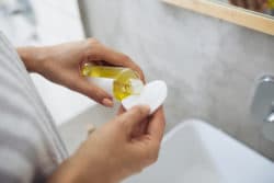 person using cosmetic oil