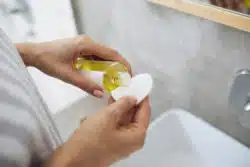 person using cosmetic oil