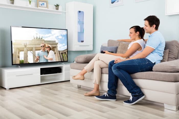 couple watching movie on samsung plasma tv
