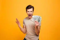 man excited holding money