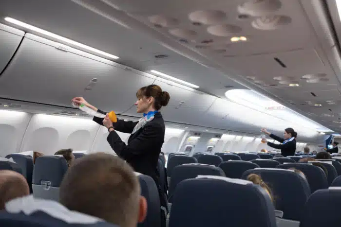 delta airline flight attendant performing safety instructions