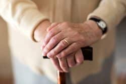Senior woman's hands on cane