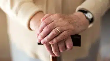 Senior woman's hands on cane