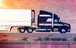 A truck travels from left to right