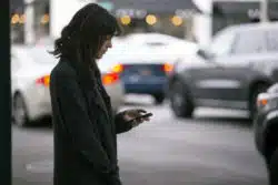 A woman is calling for a rideshare ride.