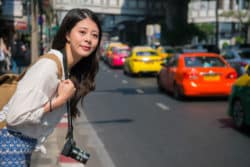 A woman looks for her rideshare.