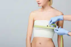 Woman with cosmetic bandages on chest