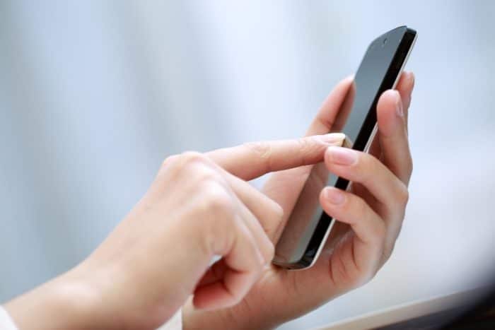 Close up of a woman using smartphone