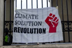 climate solution revolution sign regarding Wet'suwet'en chiefs suing Ottawa over climate change