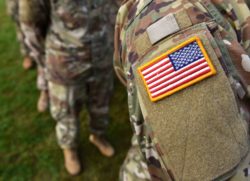US veteran soldier with US flag arm patch close up
