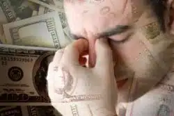 man stressed over money