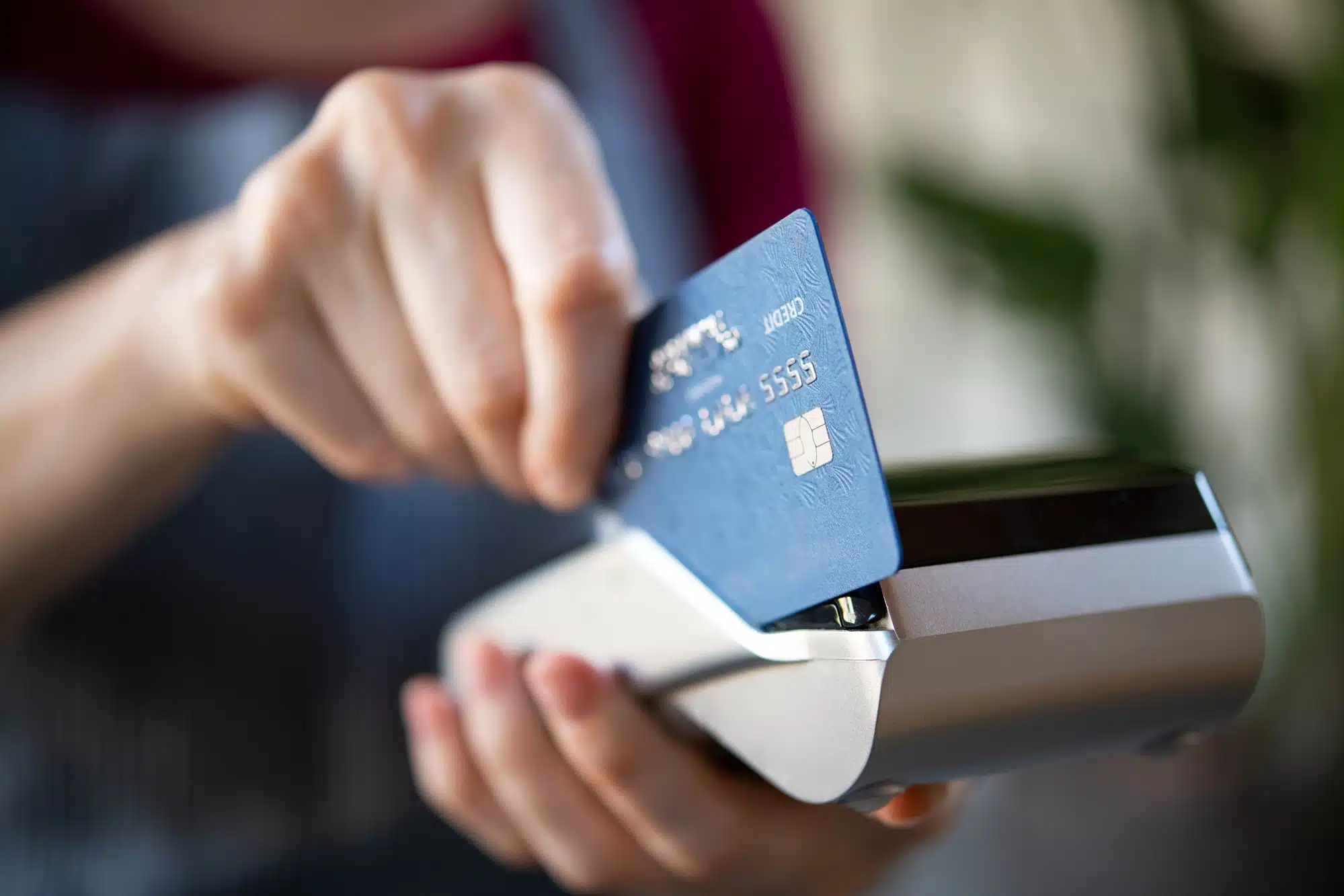 Close up of debit card being used by merchant