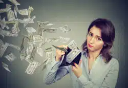 money flying out of woman's wallet