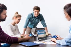 People using Facebook on laptop and phones