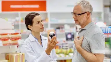 pharmacist helping male patient with medication