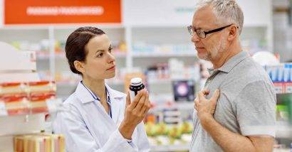 pharmacist helping male patient with medication