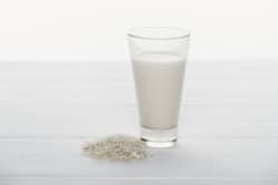 Glass of milk with rice next to it