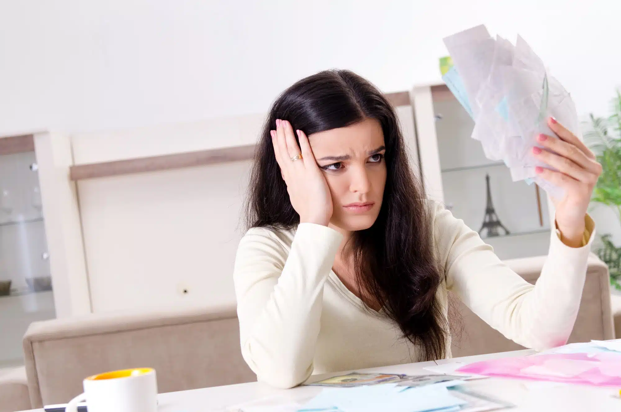 woman holding stack of receipts