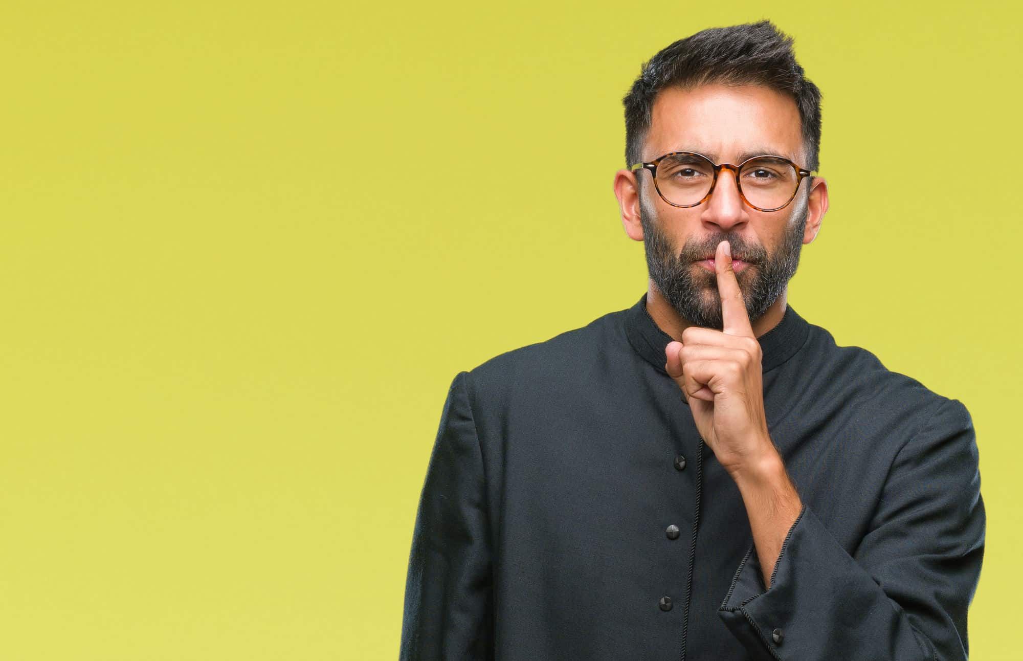 priest-with-finger-over-lips-silence