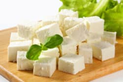 Feta Cheese cubes on cutting board regarding Glooscap lawsuit over cheese deal gone sour