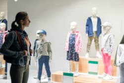 Woman window-shops for kids' clothes