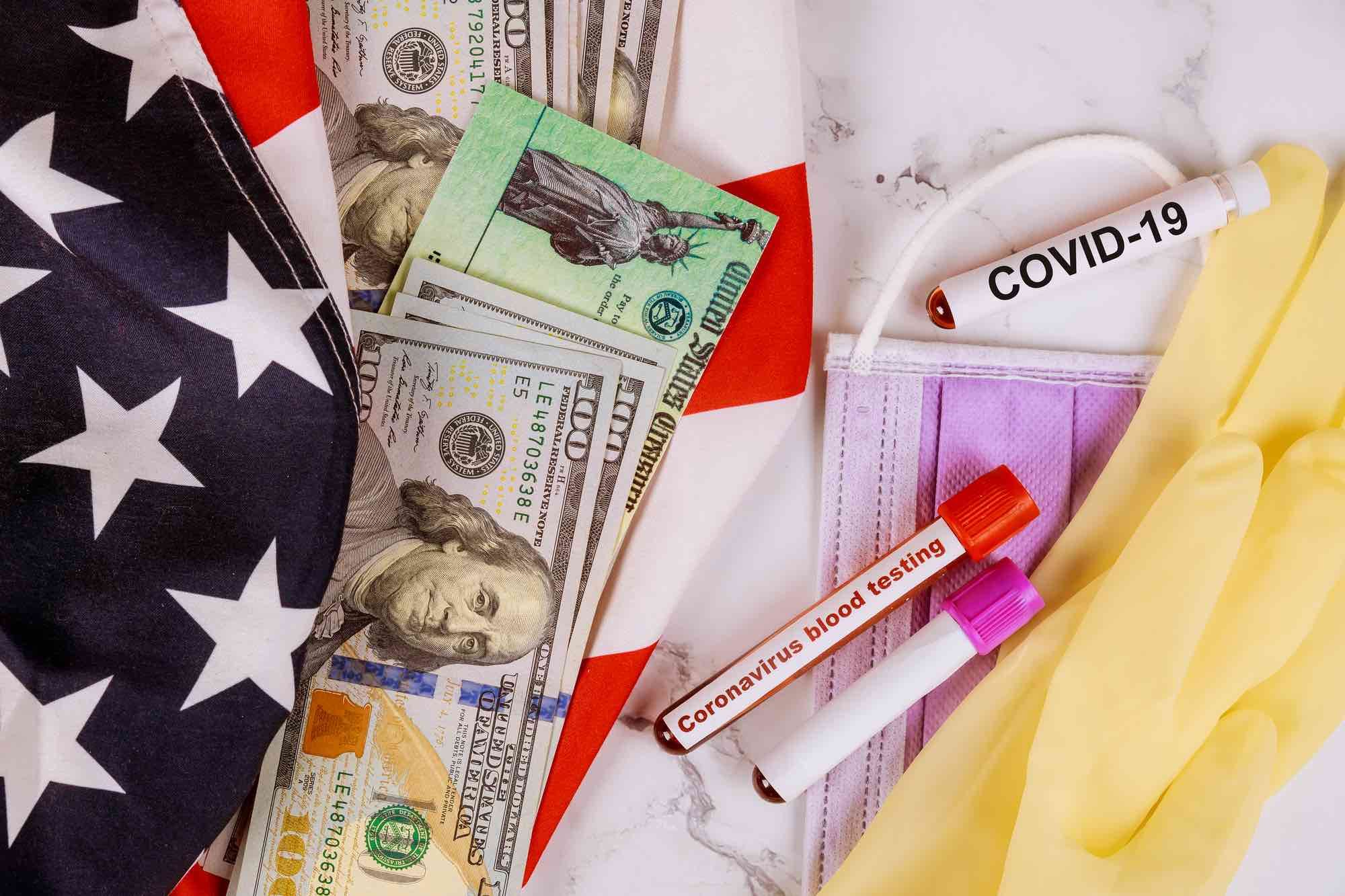 covid-19 tube with money and American flag