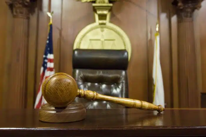 a gravel sits on top of judge's bench in courtroom