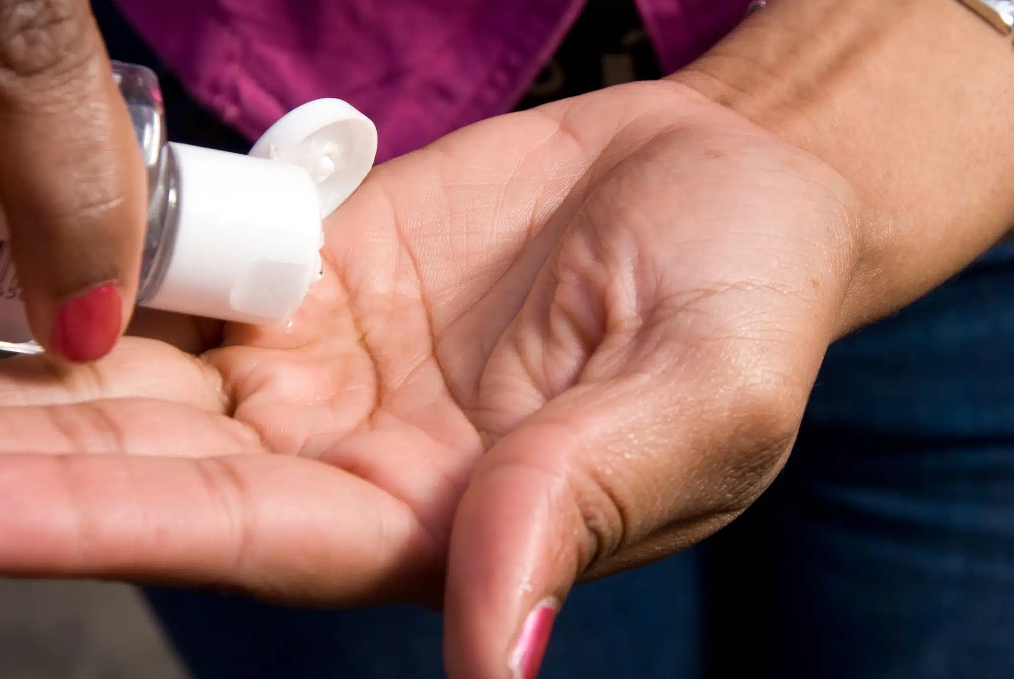 Woman applying hand sanitizer