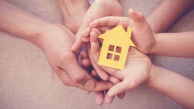 multiple hands holding a small house regarding the group of habitat for humanity residents allowed to stay in their homes amid the pandemic and a pending class action lawsuit