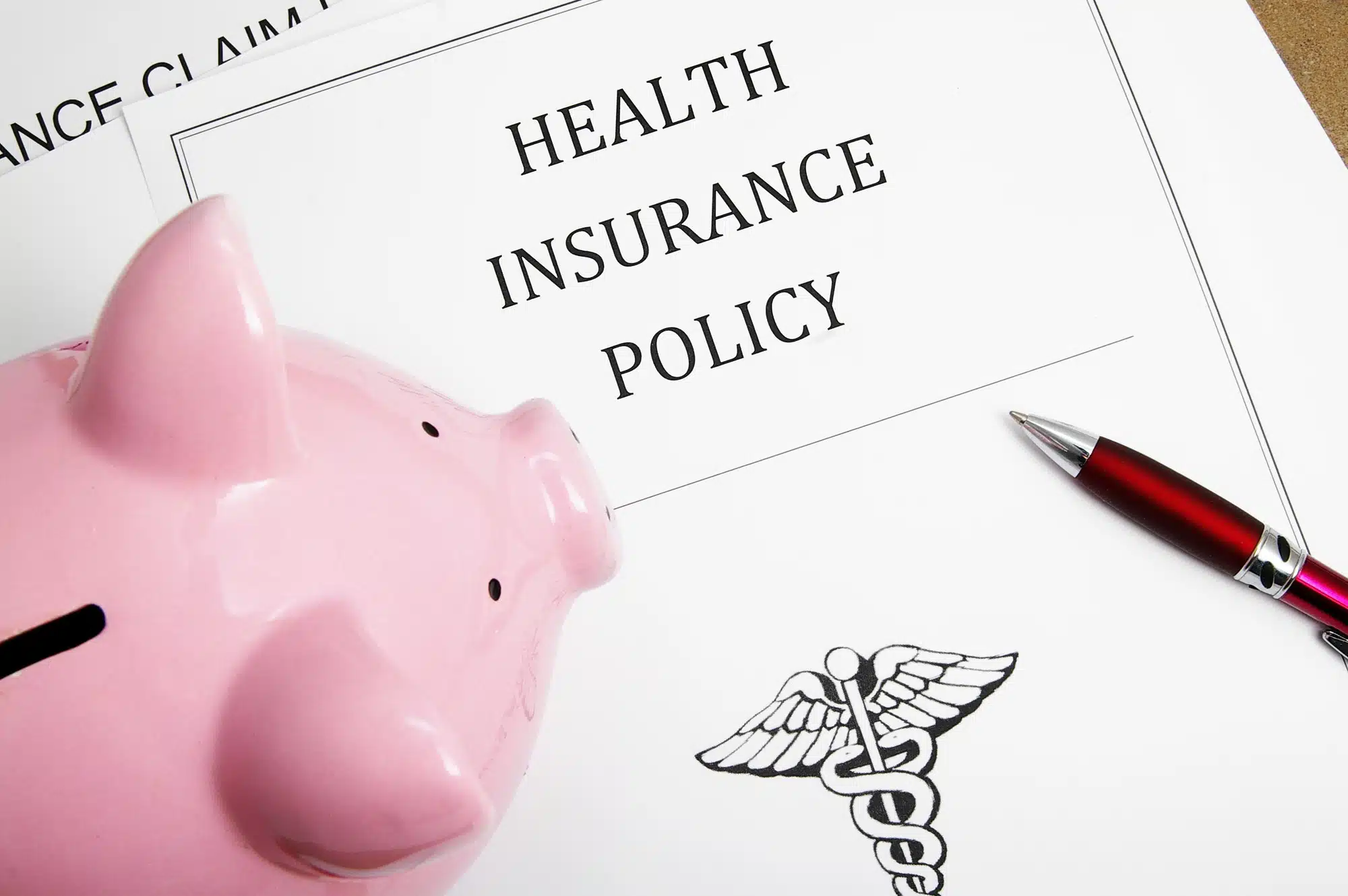 health insurance policy and piggy bank