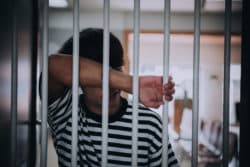 Inmate leaning on jail cell regarding visitations being cancelled at prisons and jails across Canada over the coronavirus