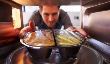 man placing food into a bosch microwave