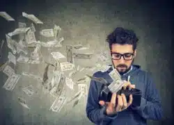 hipster with money flying out of wallet
