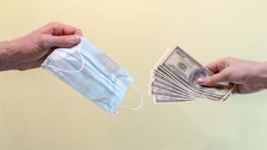 Person exchanging cash for face mask