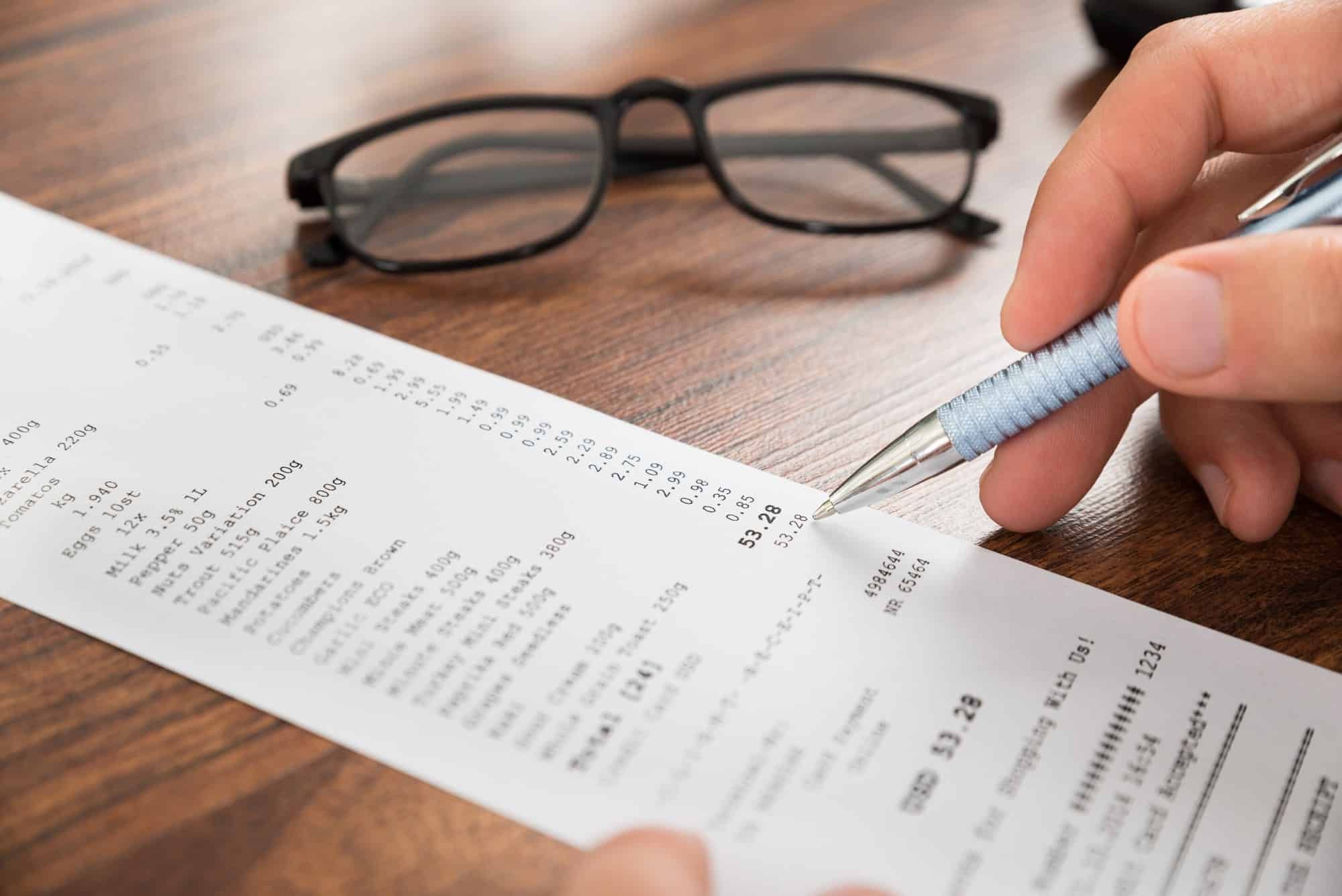 person double-checking receipt, hand close up