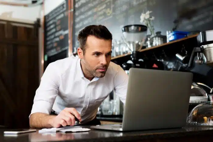 Restaurant owner on computer