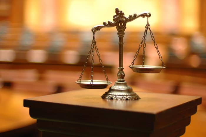 scales of justice in empty court room