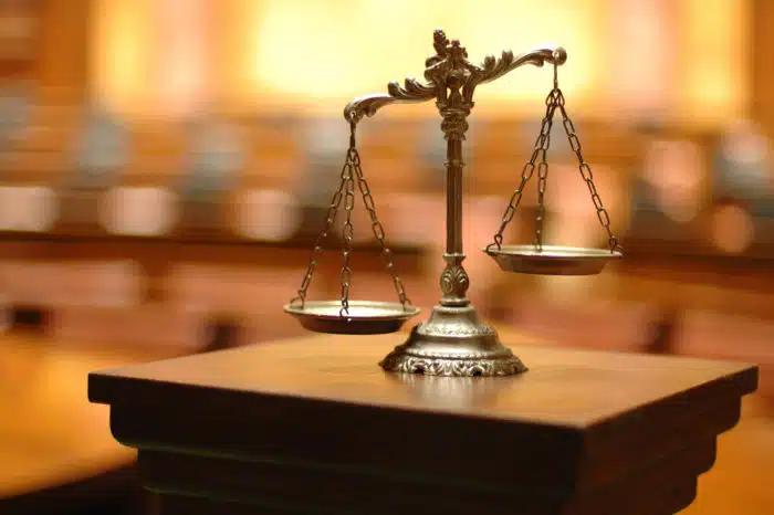 scales of justice in empty court room