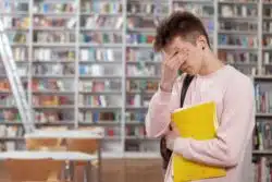 Student in library looking stressed