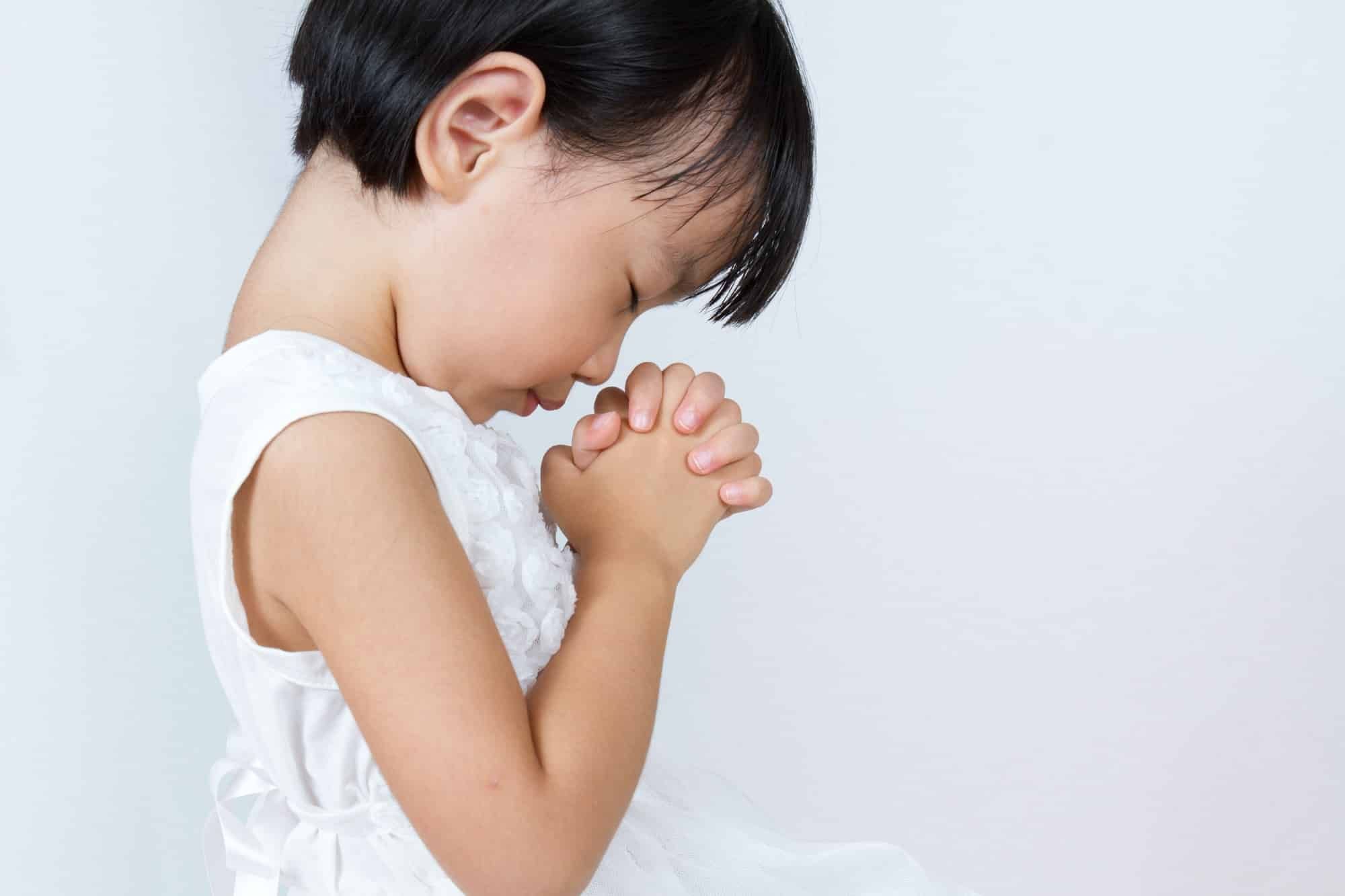 Toddler girl prays