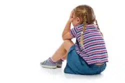 Little girl sits and cries