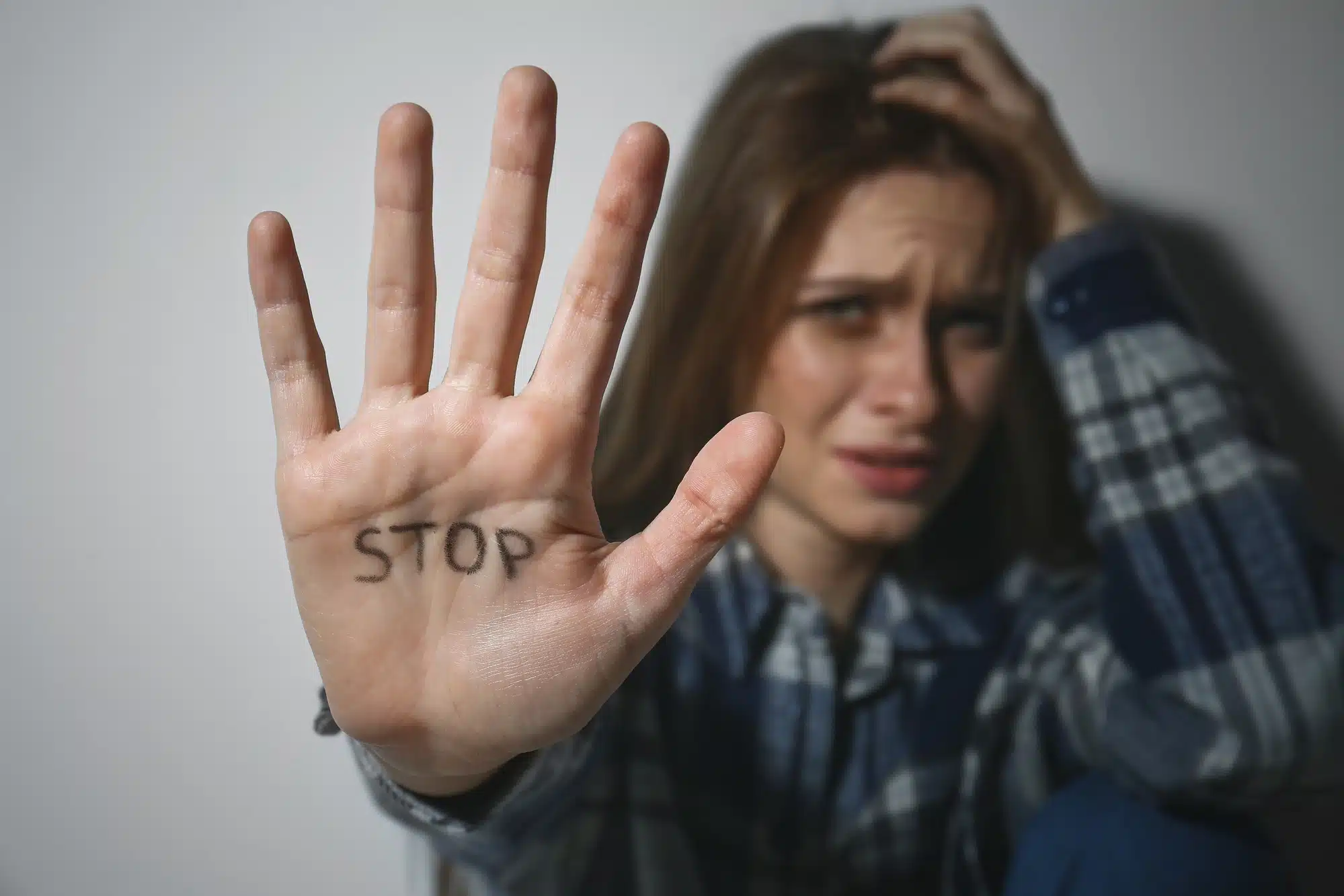 abused-teenage-girl-with-stop-on-hand
