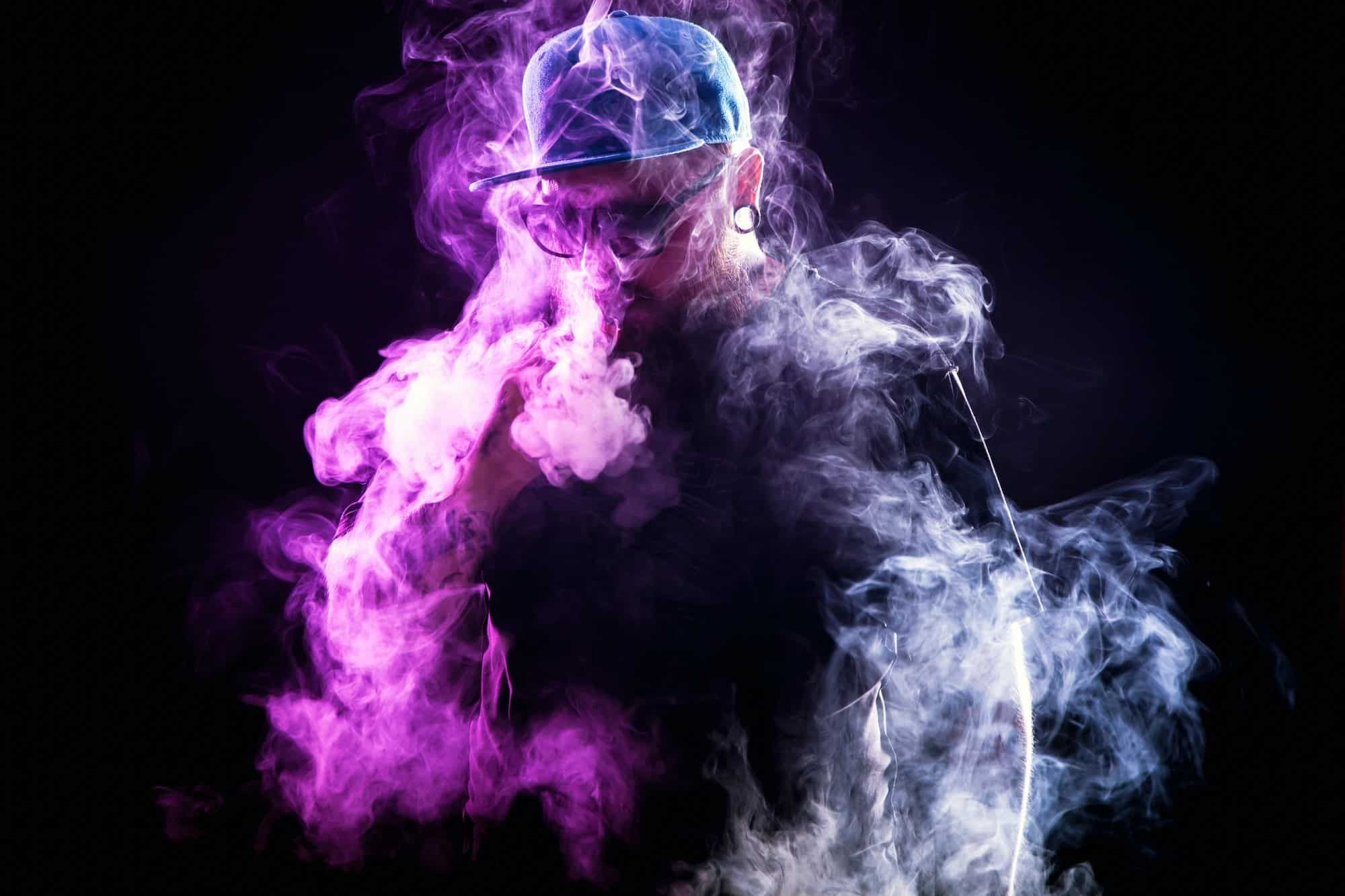 Bearded man in vaping cloud