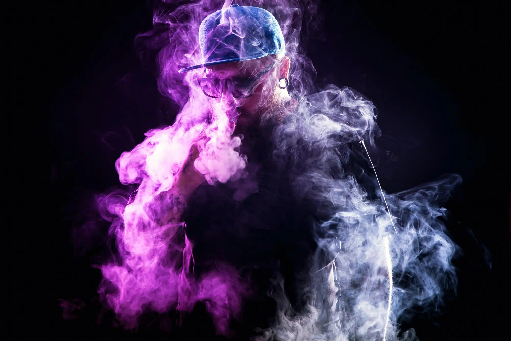 Bearded man in vaping cloud