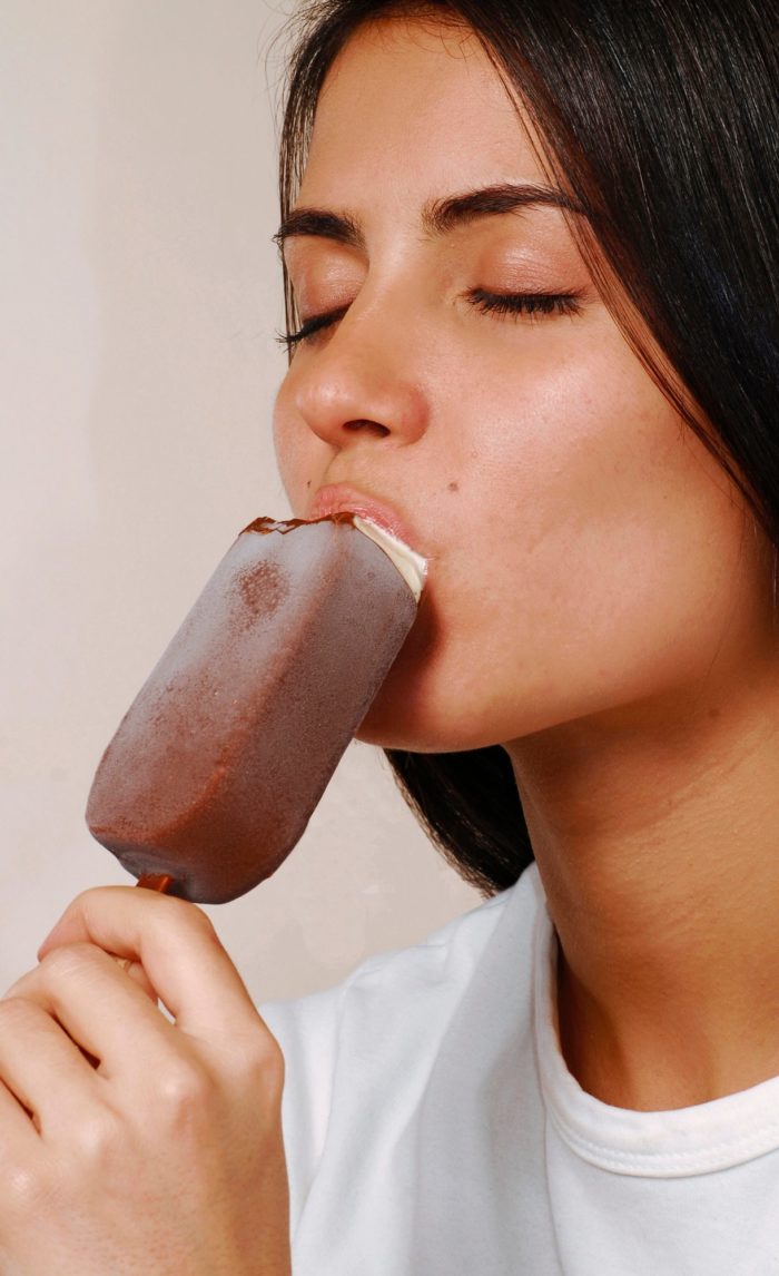 woman eating Costco ice cream bar