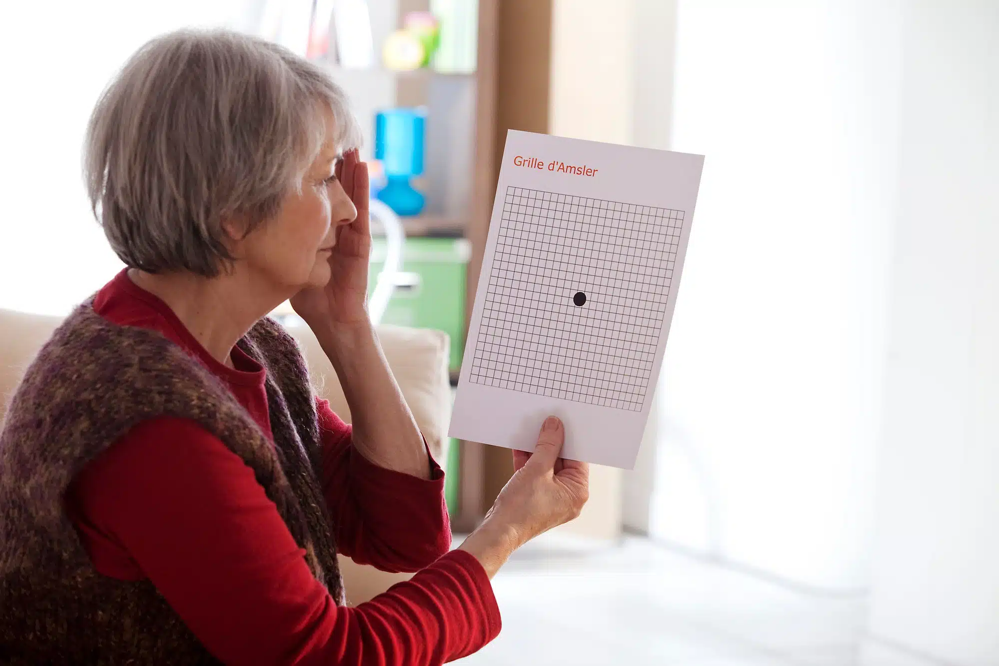 older woman taking macular degeneration eye screen