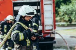 young firefighter with hose 