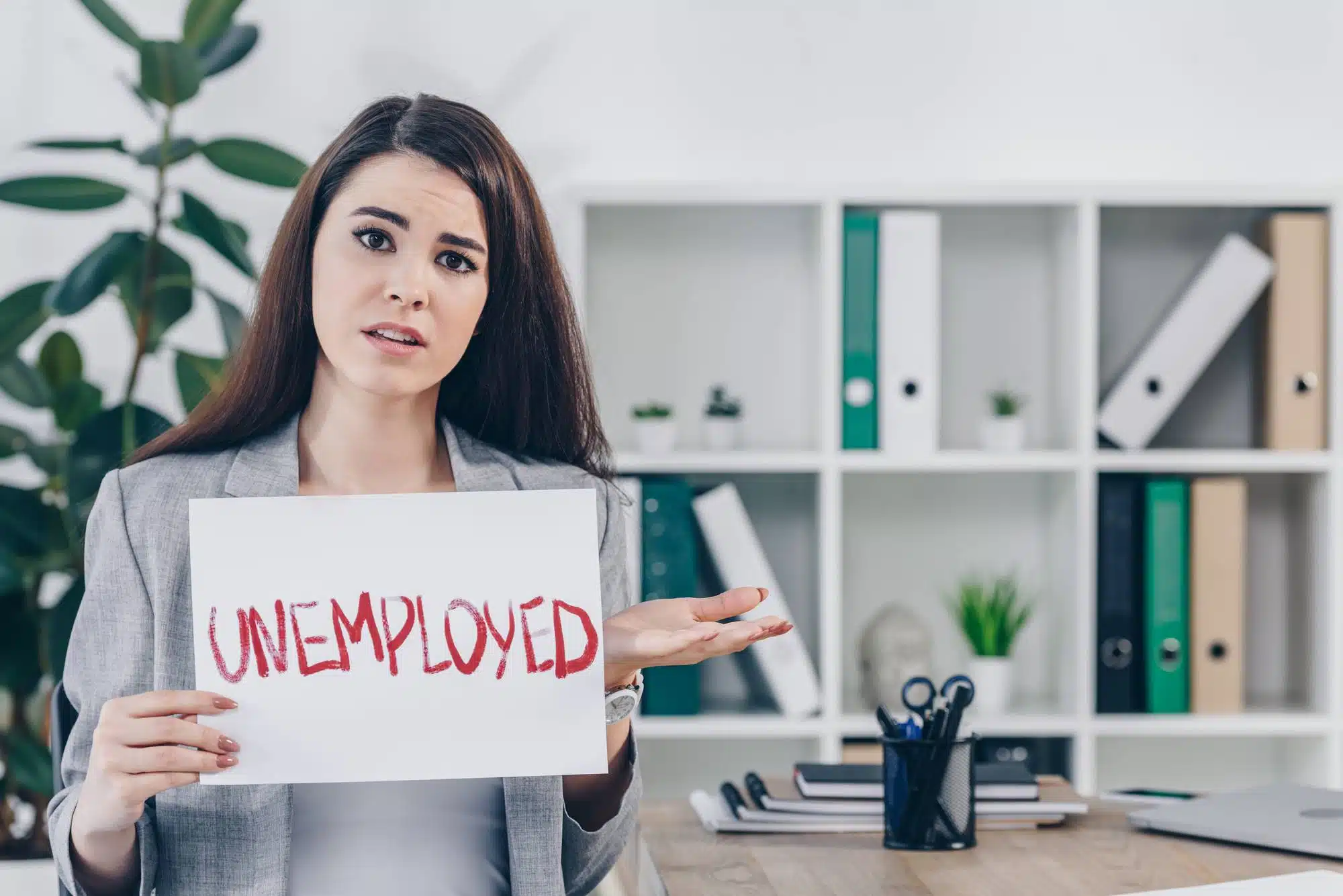 Woman holding Florida unemployment sign