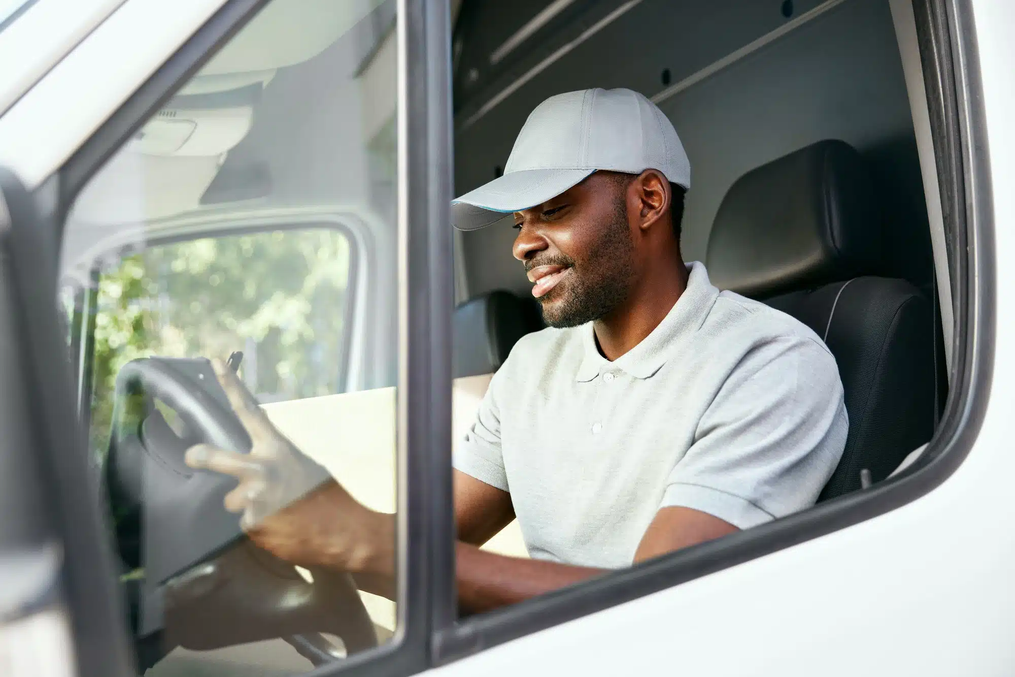 Truck driver checks address while in cab of truck