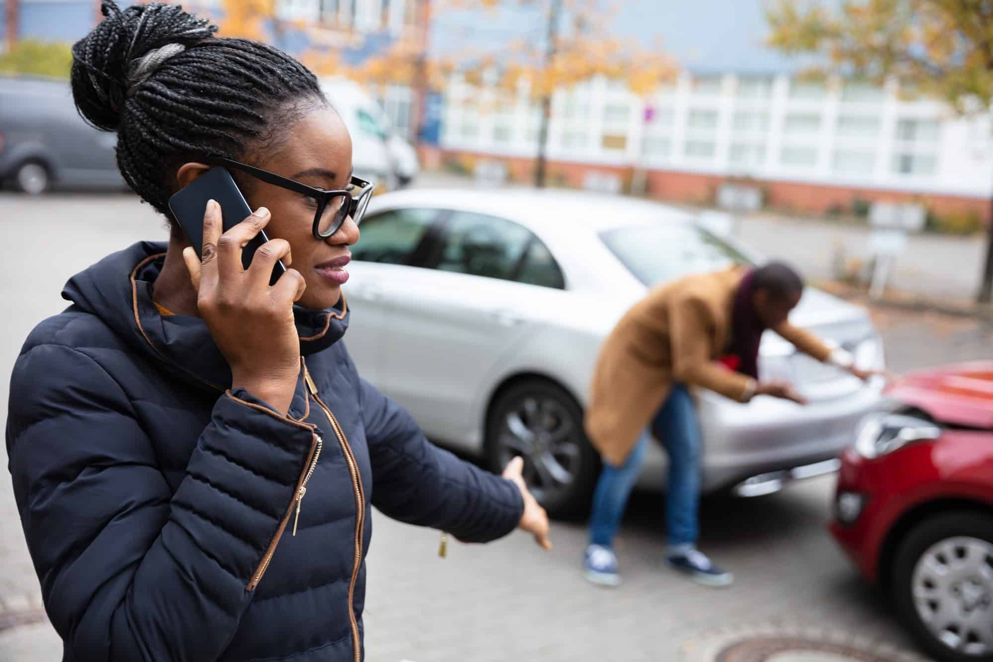 A woman makes a phone call after a crash.